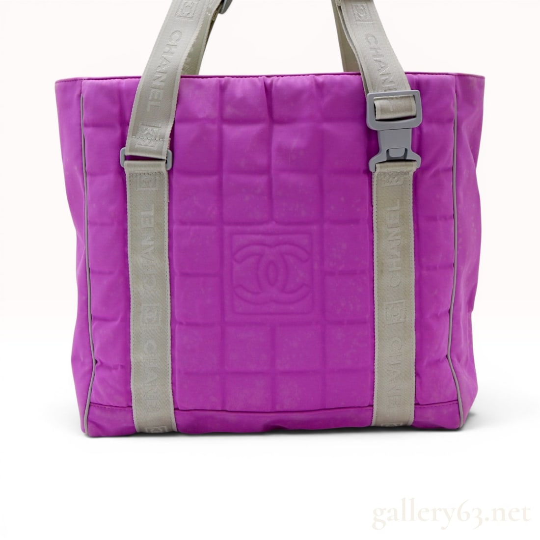 Chanel Sport Line Quilted Nylon Chocolate Bar Tote Bag: A Chanel Sport Line tote bag featuring a magenta quilted padded nylon exterior in the signature chocolate bar pattern. The front panel is decorated with a large centered embossed interlocking CC logo.