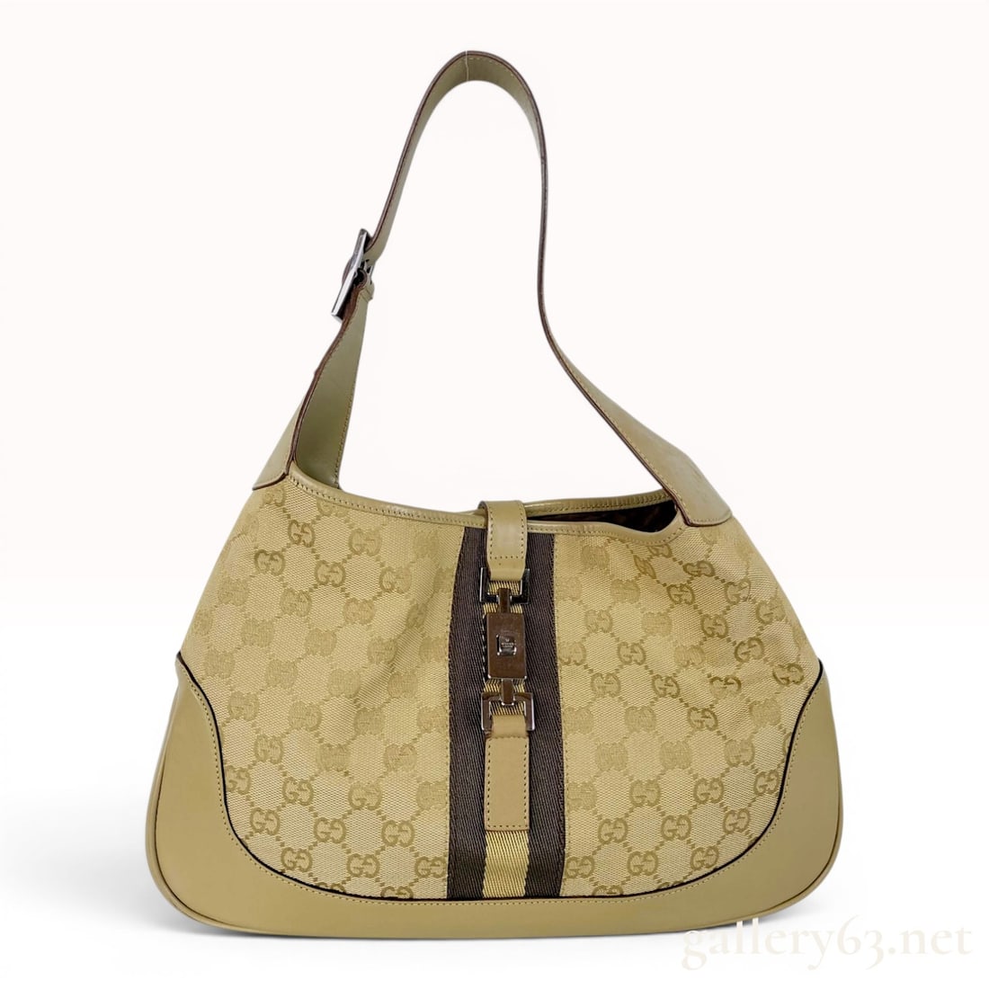 Gucci Jackie O Web Stripe GG Canvas Hobo Bag: This hobo bag by Gucci is known as the Jackie O style. It is constructed from beige and tan GG monogram canvas and features a signature central textile web stripe in shades of brown and tan. The bag i