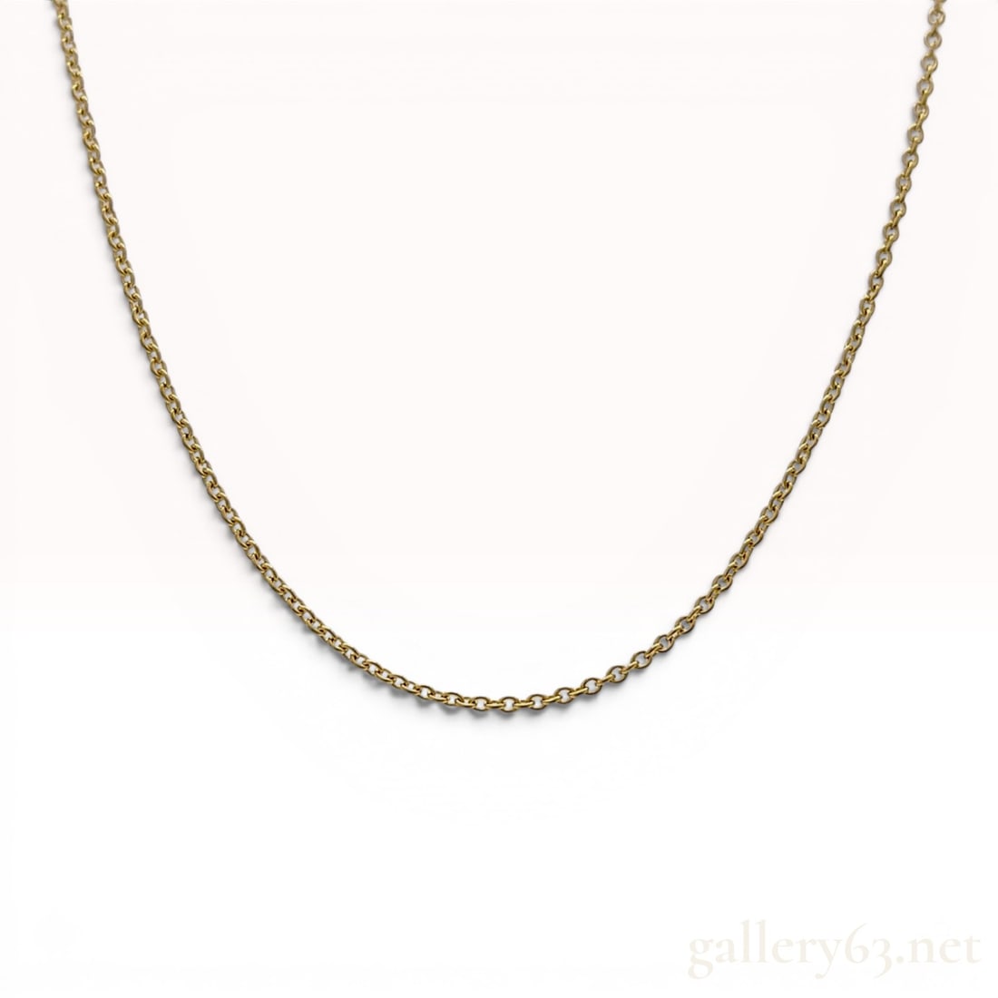 Tiffany and Co. Elsa Peretti 18K Yellow Gold Cable Link Chain Necklace: An 18 karat yellow gold chain necklace designed by Elsa Peretti for Tiffany and Co. The necklace features a fine cable link construction and is secured with a spring ring clasp. A rectangular metal ta