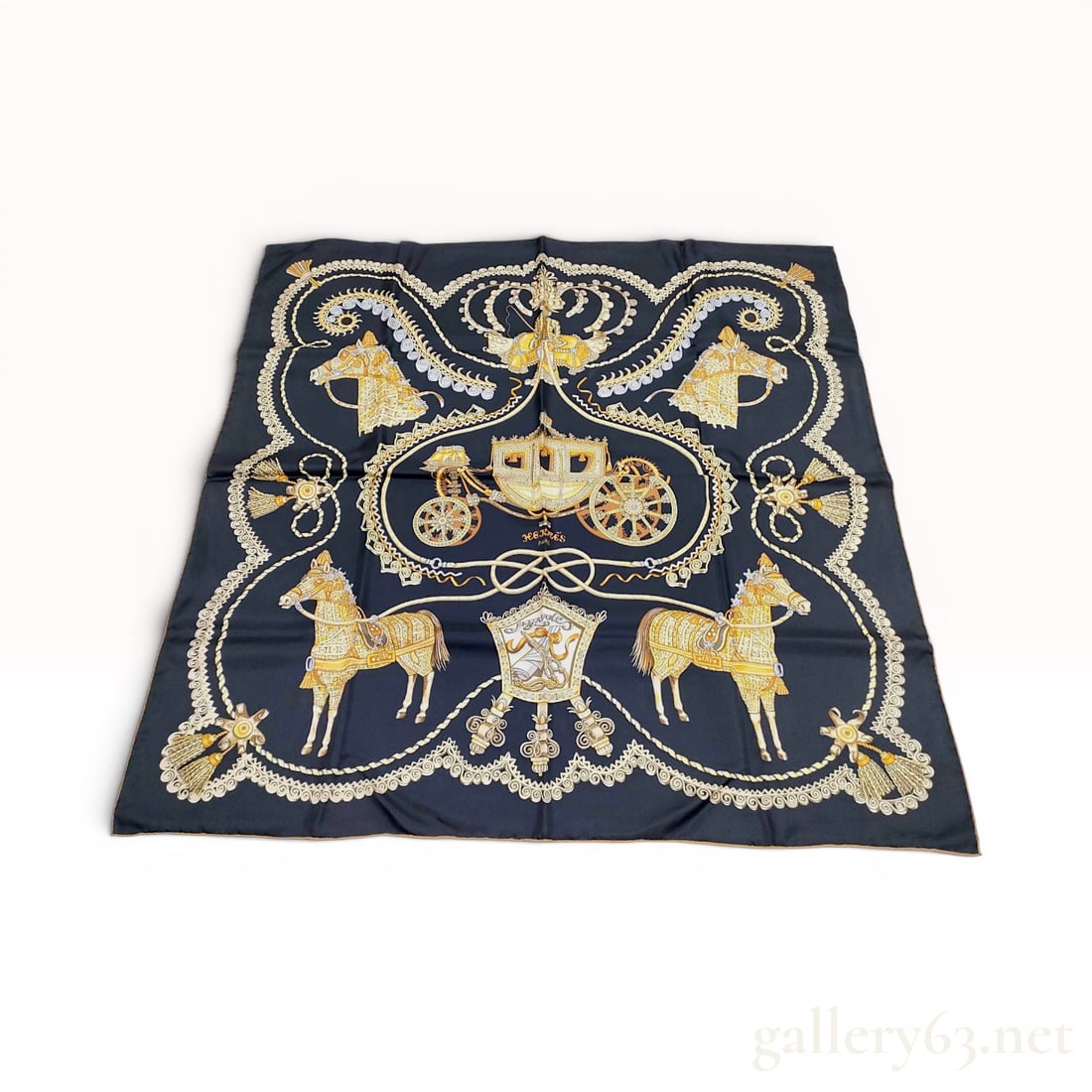 Hermes Silk Scarf in Paperoles Pattern: A square Hermes silk carre scarf featuring the Paperoles pattern designed by Claudia Stuhlofer-Mayr. The intricate design is printed on a black ground and depicts an ornate central carriage surrounded