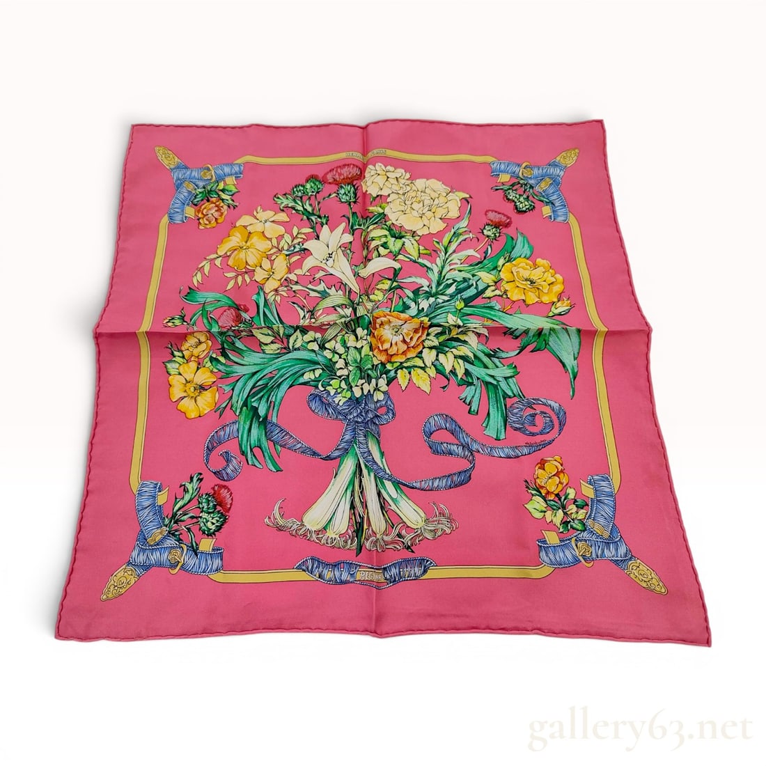 Hermes Regina Silk Gavroche Scarf: A 100 percent silk gavroche pocket square scarf from Hermes Paris featuring the Regina pattern designed by Leila Menchari. The design consists of a vibrant pink ground with a large central floral bouq