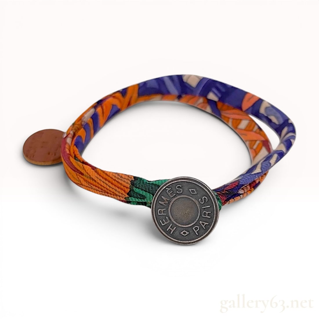 Hermes Double Tour Printed Silk Bracelet: An authentic Hermes double-wrap silk cord bracelet featuring a vibrant, multi-colored abstract print in shades of orange, purple, blue, green, and yellow. The bracelet is constructed from printed silk