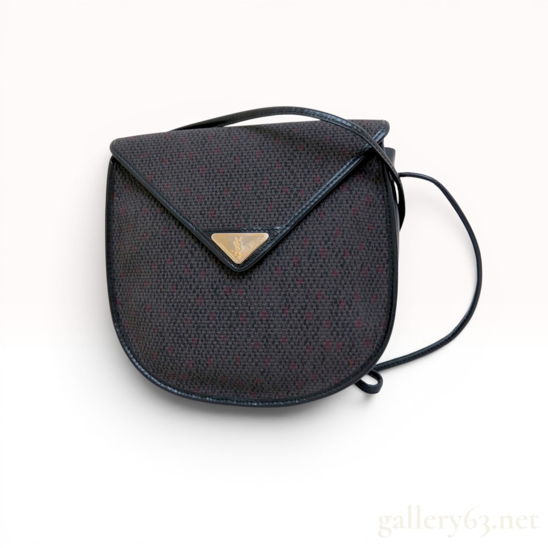 Vintage Yves Saint Laurent Woven Fabric and Leather Shoulder Bag: This vintage Yves Saint Laurent shoulder bag features a rounded rectangular silhouette with a woven fabric body and black leather trim. The main body is constructed from a dark charcoal and black text