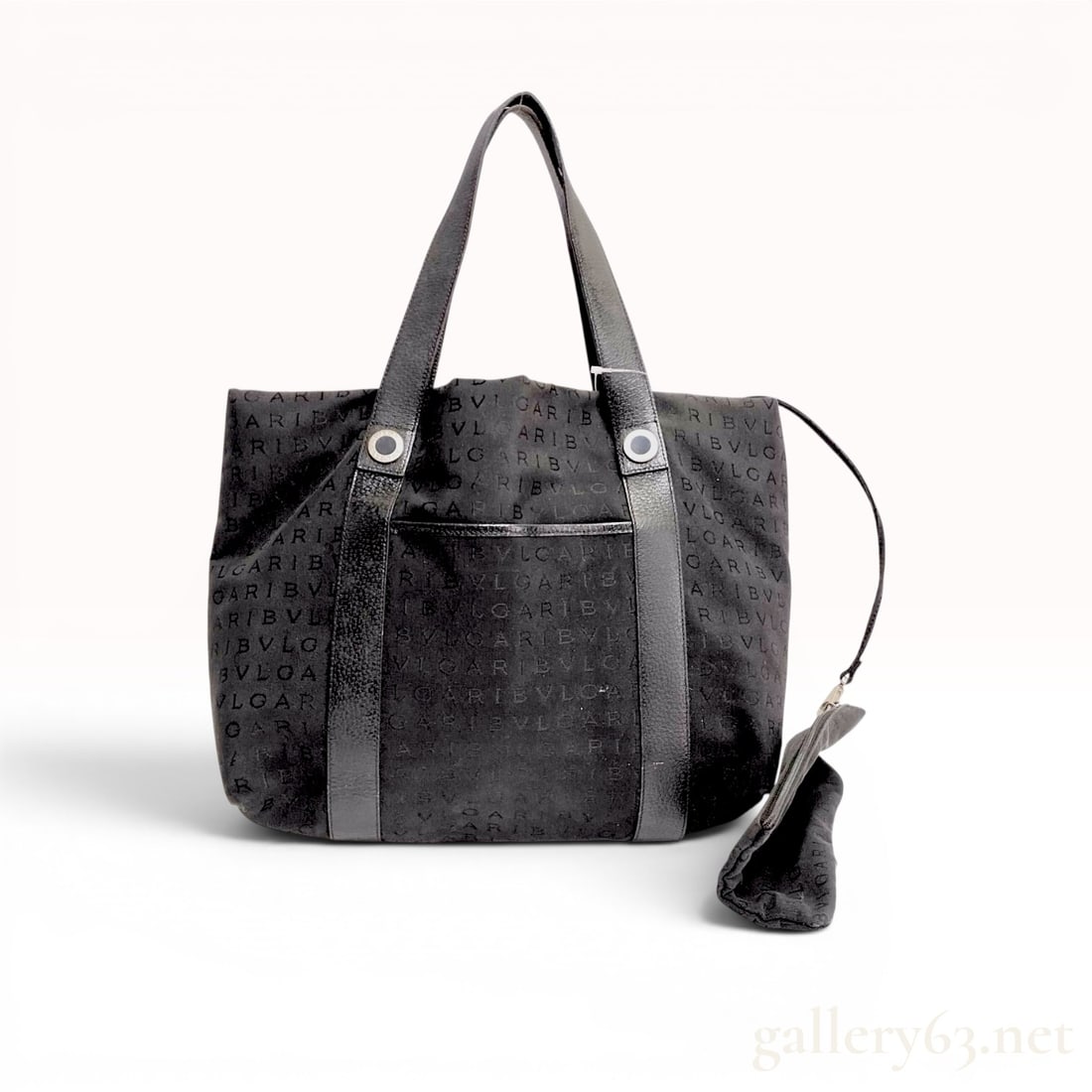 Bvlgari Black Logomania Jacquard Canvas and Leather Tote Bag: This Bvlgari tote bag is crafted from black jacquard canvas featuring a repeating woven monogram logo pattern. The exterior is accented with black pebbled leather trim, including two flat shoulder str