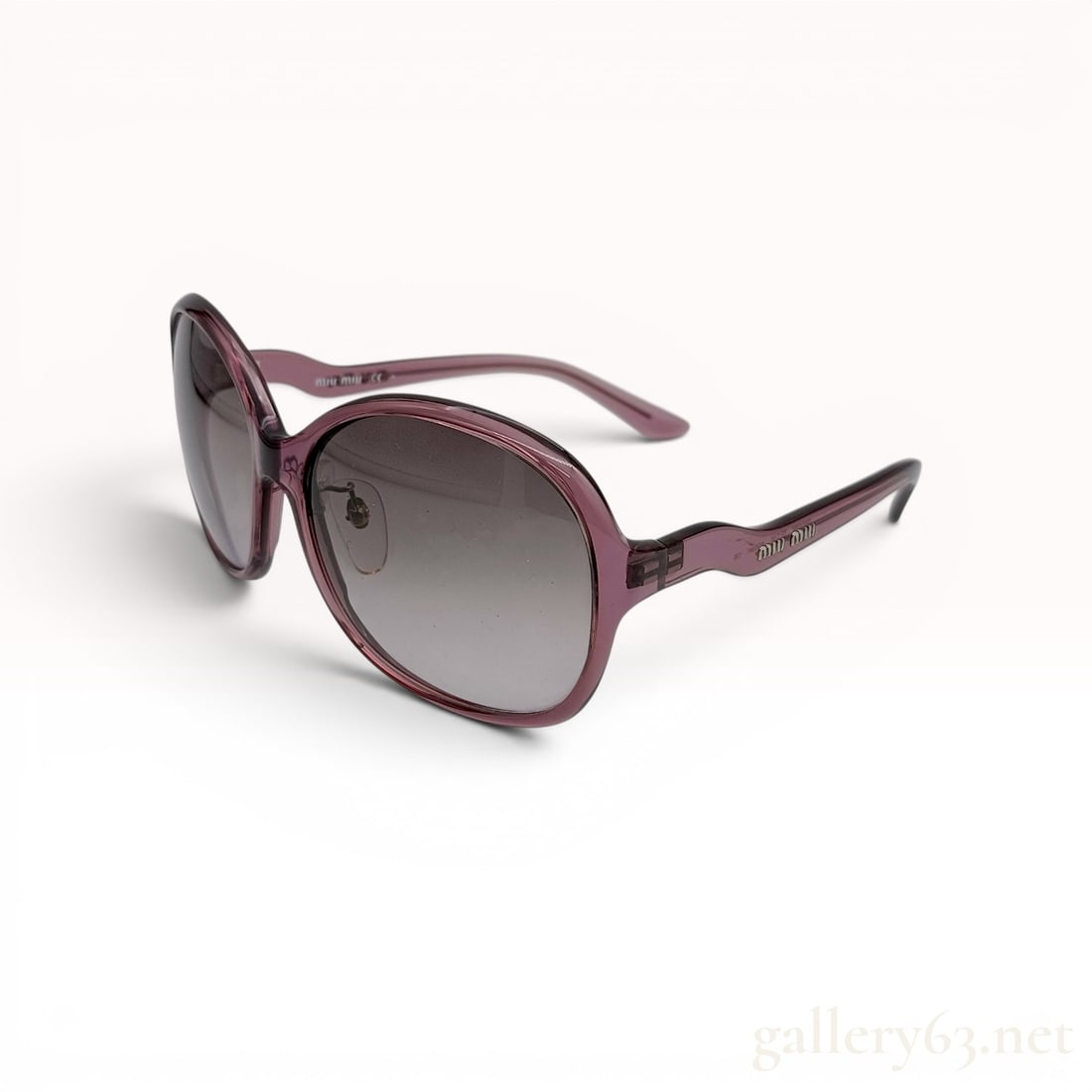 Miu Miu Translucent Plum Acetate Oversized Sunglasses Model SMU08M: These Miu Miu sunglasses feature oversized, rounded oval frames constructed from translucent plum acetate. The temples are designed with a distinctive undulating wavy profile and bear raised silver-to