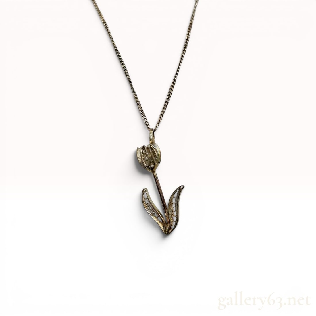 Rare Tiffany & Co. Sterling Silver Tulip Motif Filigree Pendant Necklace with Box: This Tiffany & Co. sterling silver necklace features a pendant designed as a stylized tulip. The flower head and dual curved leaves are crafted with intricate openwork filigree detailing throughou