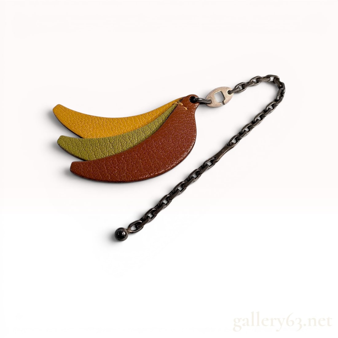 Hermes Grained Leather Banana Fruit Bag Charm with Sterling Silver Chain: Hermes leather bag charm featuring a fruit motif designed as three layered, banana-shaped segments. The segments are constructed from grained leather in graduated colors of yellow, lime green, and bro