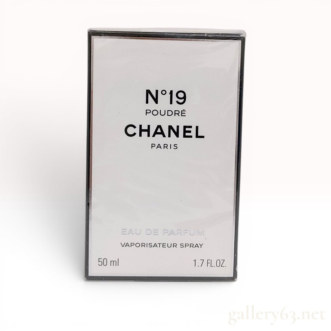 Chanel No. 19 Poudre Eau de Parfum Vaporisateur Spray, 50 ml: Chanel No. 19 Poudre Eau de Parfum is presented in a 50 ml (1.7 fl. oz.) vaporisateur spray format. The item is contained within its original rectangular white card box, which features a black border 