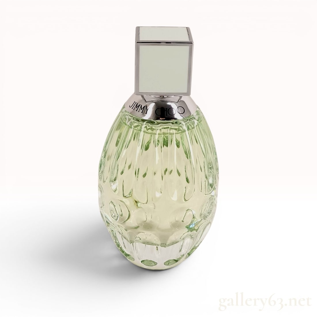 Jimmy Choo Floral Eau de Toilette, 60ml with Box: Jimmy Choo Floral Eau de Toilette is presented in a pale green, textured glass ovoid bottle. The neck features a polished silver-toned collar engraved with JIMMY CHOO and is topped with an opaque pale
