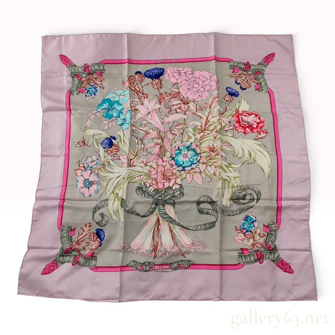 Hermes Regina Silk Carre 90 by Leila Menchari: An Hermes 100% silk twill scarf in the Regina pattern, originally designed by Leila Menchari and first issued in 1972. The design features a grey central field depicting a large floral bouquet includi