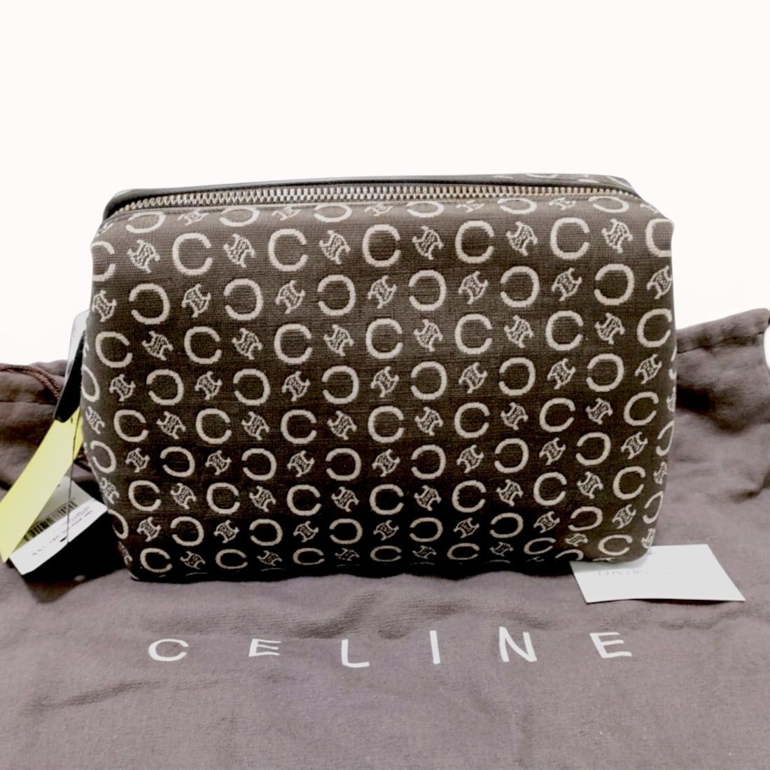 Celine Macadam C Logo and Triomphe Jacquard Cosmetic Pouch: A Celine cosmetic pouch featuring a woven jacquard canvas body in the signature Macadam pattern. The pattern displays repeating beige "C" and Triomphe logos against a brown ground. The pouch is