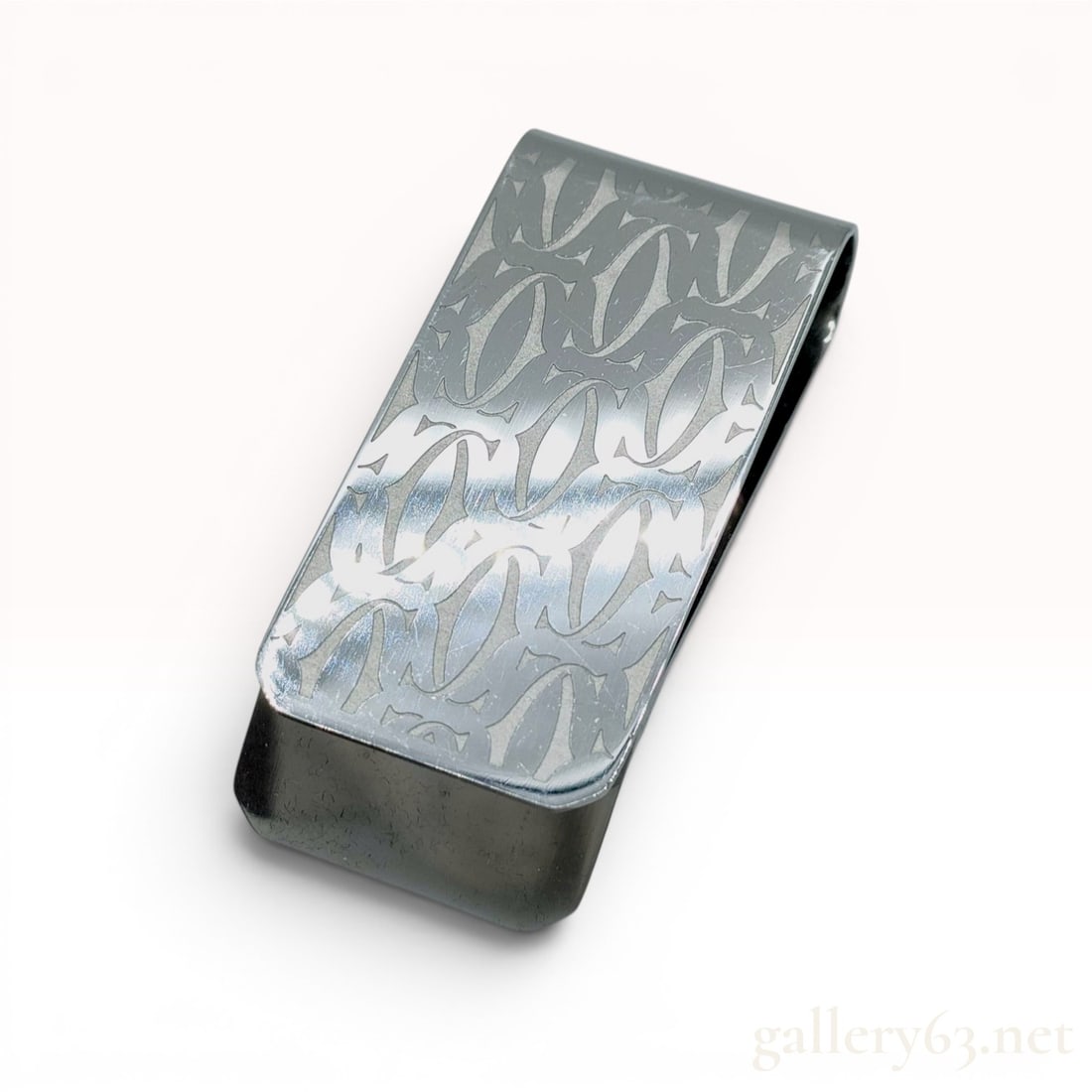 Cartier C de Decor Logo Money Clip in Silver-Tone Metal: A Cartier C de Decor money clip crafted from silver-tone metal. The exterior face features an engraved repeating pattern of the Cartier Double C logo. The piece is constructed from a single folded met