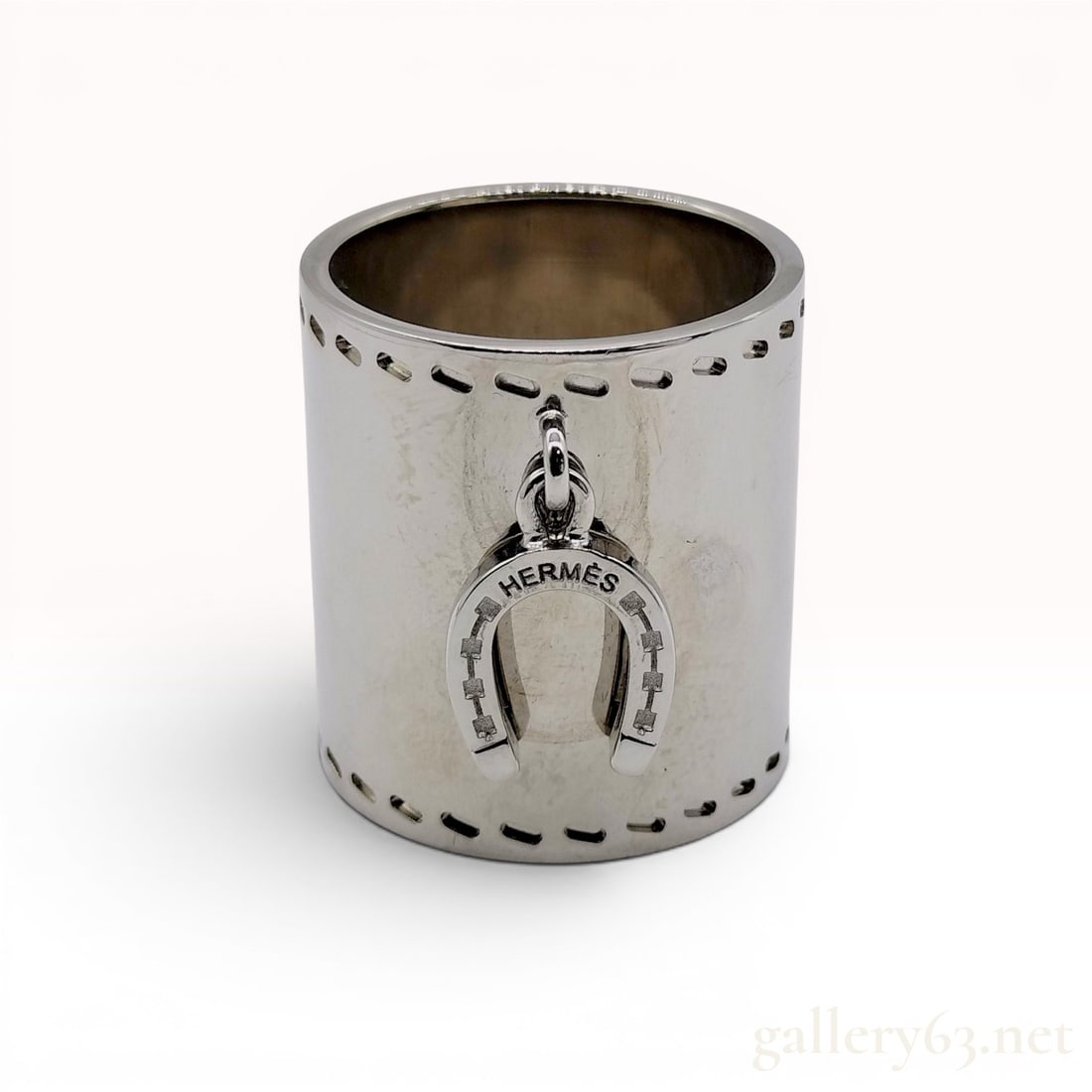 Hermes Silver-Tone Horseshoe Charm Scarf Ring with Box: A silver-tone metal scarf ring manufactured by Hermes. The item is designed as a cylindrical band with decorative rectangular indentations around the top and bottom edges resembling top-stitching. A d