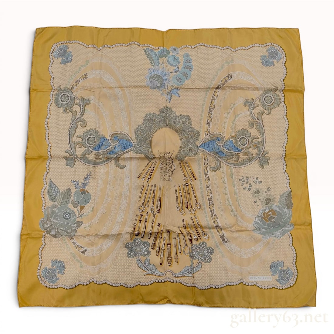 Hermes Silk Scarf Les Dentelles Pattern by Annie Faivre: A Hermes silk twill scarf in the Les Dentelles (The Laces) pattern, designed by Annie Faivre and first issued in 1993. The composition features a complex central motif of lace-making bobbins surrounde