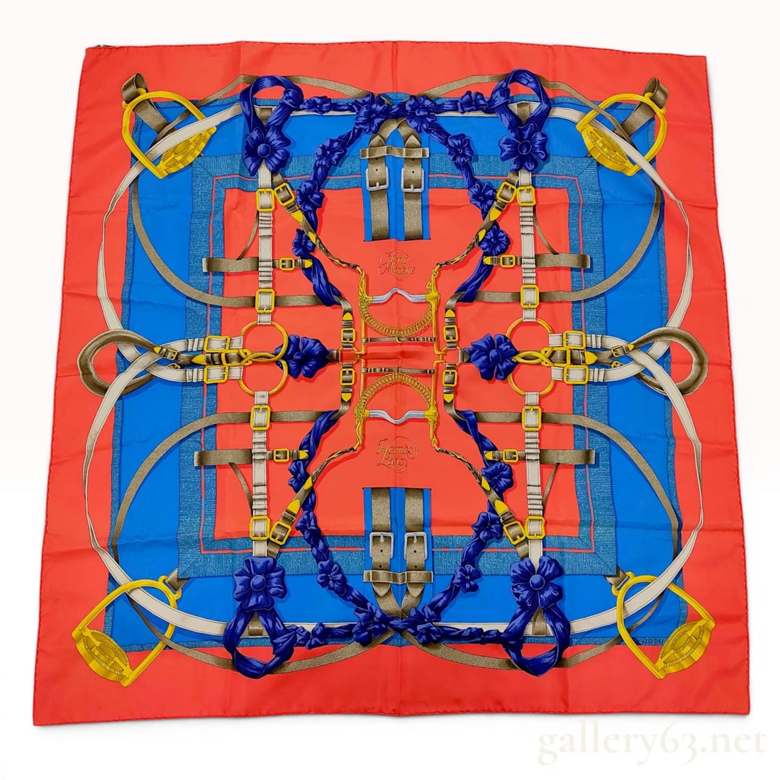 Hermes Paris Grand Manege Silk Scarf: An Hermes Paris silk twill scarf featuring the Grand Manege pattern, originally designed by Henri d'Origny. The equestrian-themed design depicts a central arrangement of riding equipment, including