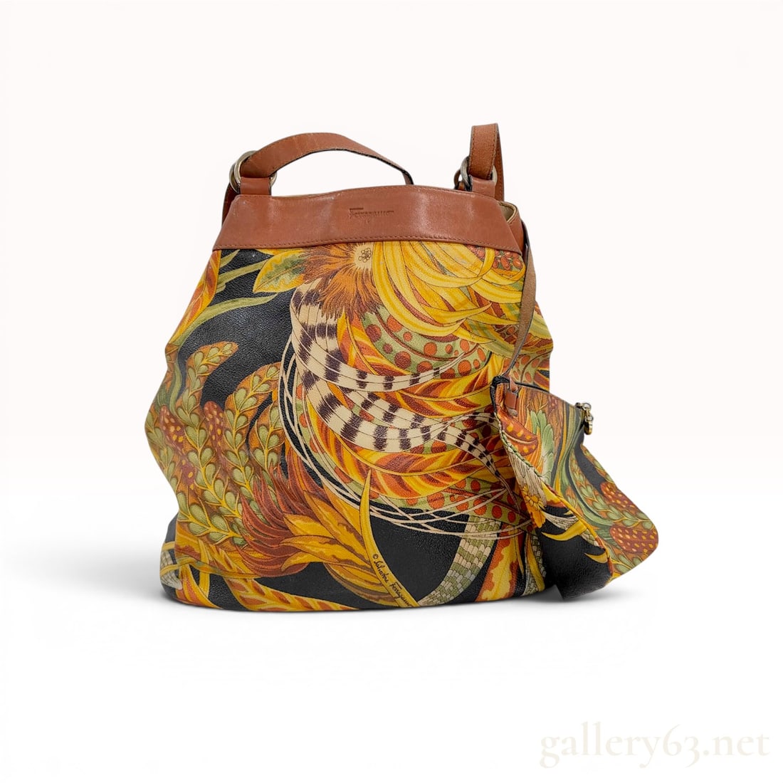 Salvatore Ferragamo Vintage Botanical Print PVC and Leather Bucket Bag with Pouch: A vintage Salvatore Ferragamo bucket-style shoulder bag accompanied by a matching detached zippered pouch. The bag is constructed from a printed coated canvas, often referred to as PVC, featuring a