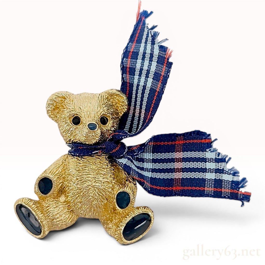 Burberrys Vintage Gold-Toned Teddy Bear Figural Brooch with Plaid Scarf: This vintage figural costume brooch, produced by Burberrys, depicts a seated teddy bear. The piece is crafted from gold-toned metal featuring a textured nugget-style finish on the front and a brushed 
