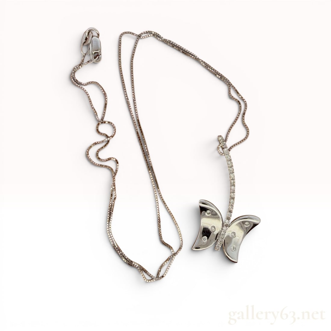 14K White Gold Diamond Butterfly Necklace: Measures 17" long, weighs 3.8 grams, and features 0.15cttw of diamonds. 3.8 grams