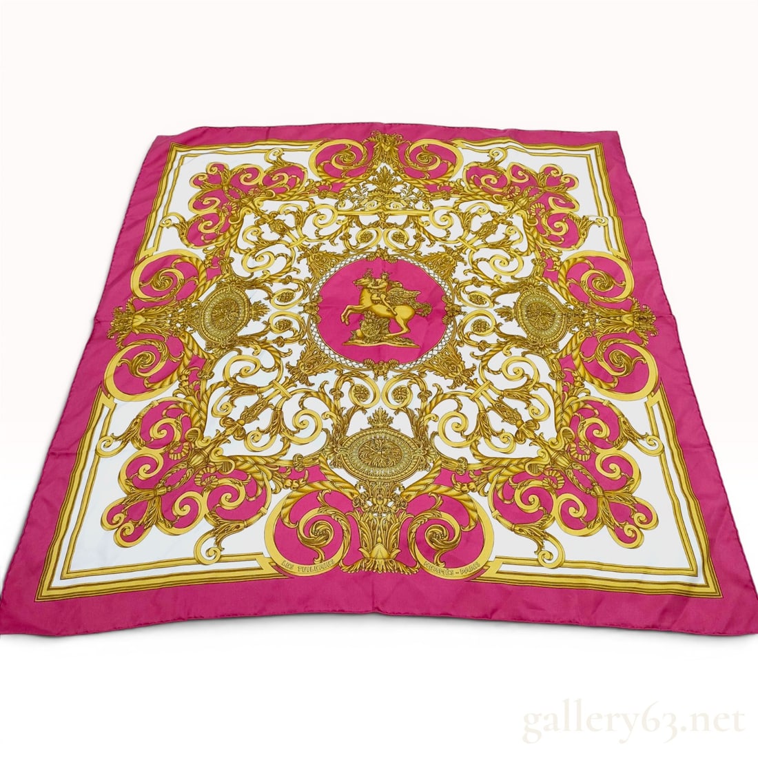 Hermes Les Tuileries 90cm Silk Twill Scarf in Fuchsia and Gold: Hermes square silk twill scarf titled Les Tuileries, originally designed by Joachim Metz in 1992. The design features a central circular medallion on a fuchsia pink ground depicting the mythological f