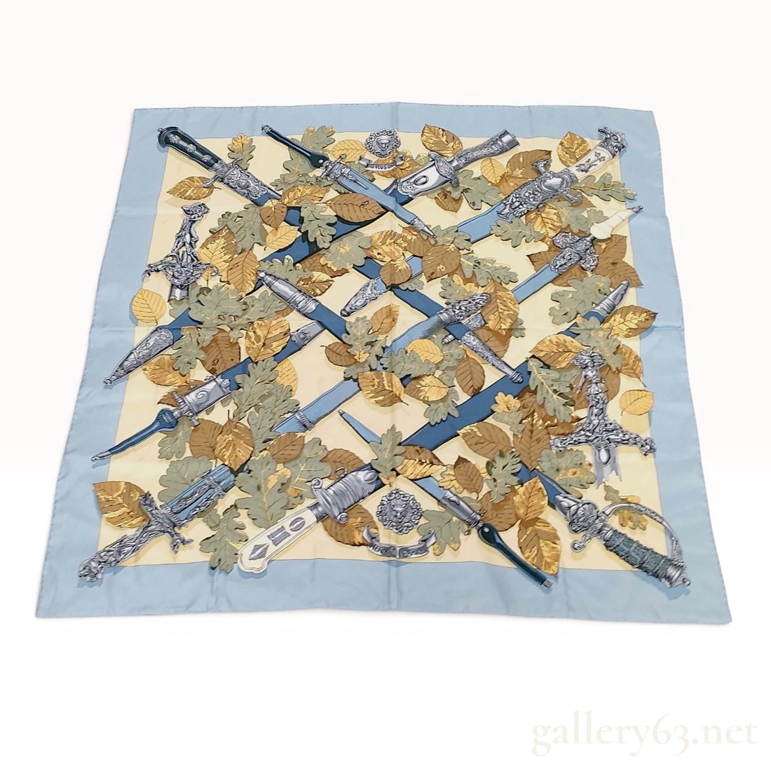 Hermes Au Plus Dru Silk Scarf: Hermes silk twill scarf featuring the Au Plus Dru pattern designed by artist Zoe Pauwels. The central motif consists of several highly decorative historical daggers and short swords with ornate hilts 