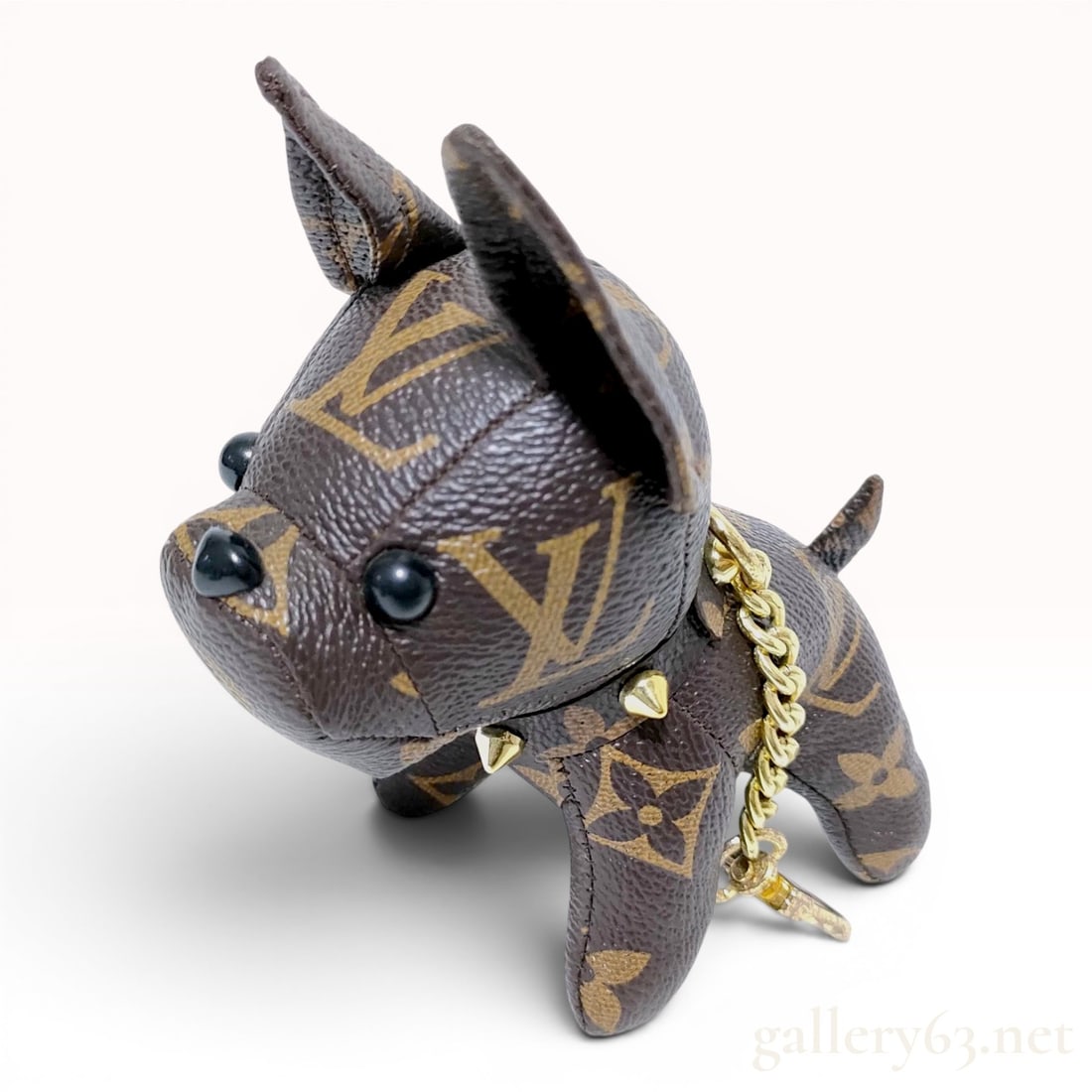 Louis Vuitton Monogram Canvas French Bulldog Bag Charm: This bag charm and key holder is designed in the form of a French Bulldog, crafted from Louis Vuitton Monogram coated canvas. The figure features the classic brown monogram pattern and is constructed 