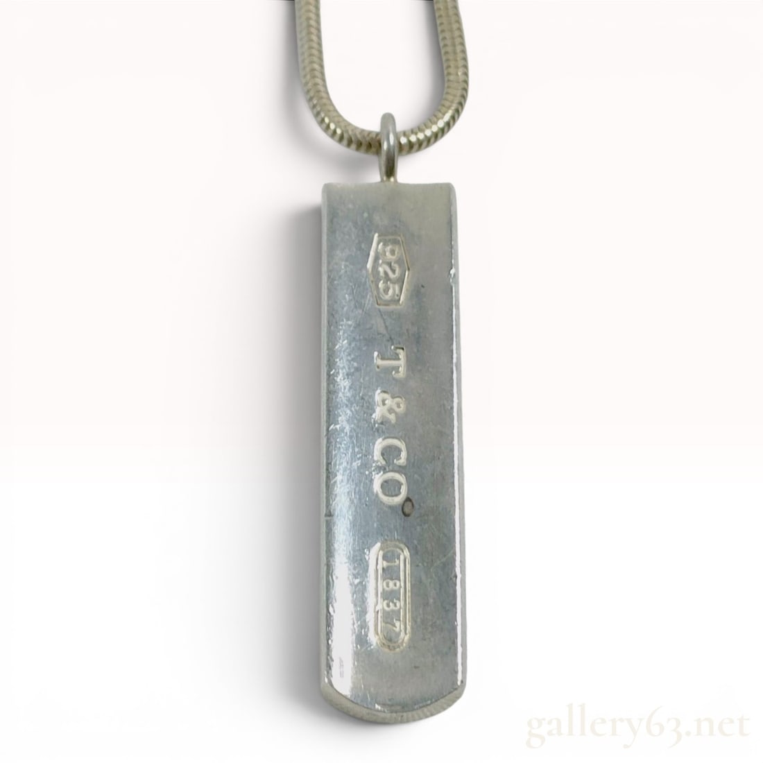 Tiffany & Co. Sterling Silver 1837 Bar Pendant Necklace: A sterling silver bar pendant necklace by Tiffany & Co. from the 1837 collection. The piece features a rectangular bar pendant with a slightly curved profile suspended from a round snake chain. The ne