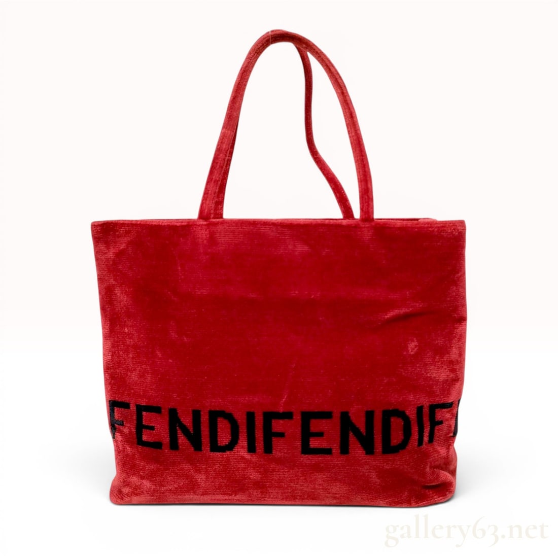 Fendi Red Ribbed Velvet Logo Shopper Tote Bag: A Fendi shopper tote bag crafted from vibrant red ribbed velvet with a plush texture. The exterior features a prominent wrap-around logo in large black block letters reading FENDI. The bag is designed