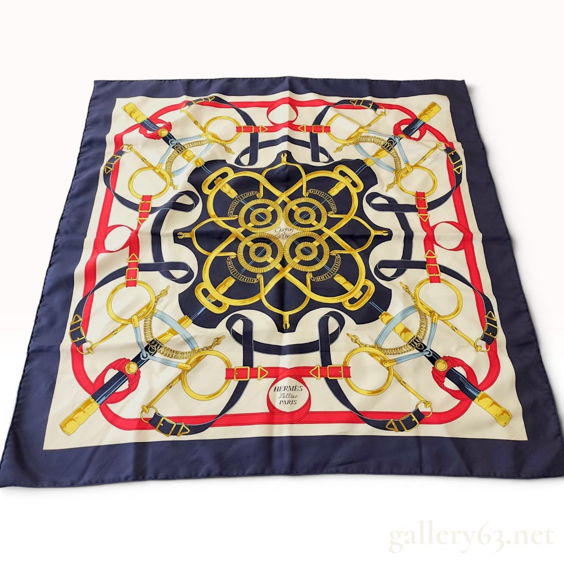 Hermes Paris Eperon d'Or Silk Twill Scarf 90: This silk twill scarf by Hermes Paris features the classic Eperon d'Or (Golden Spur) pattern designed by Henri d'Origny. The design presents a symmetrical equestrian composition of interlacing leather