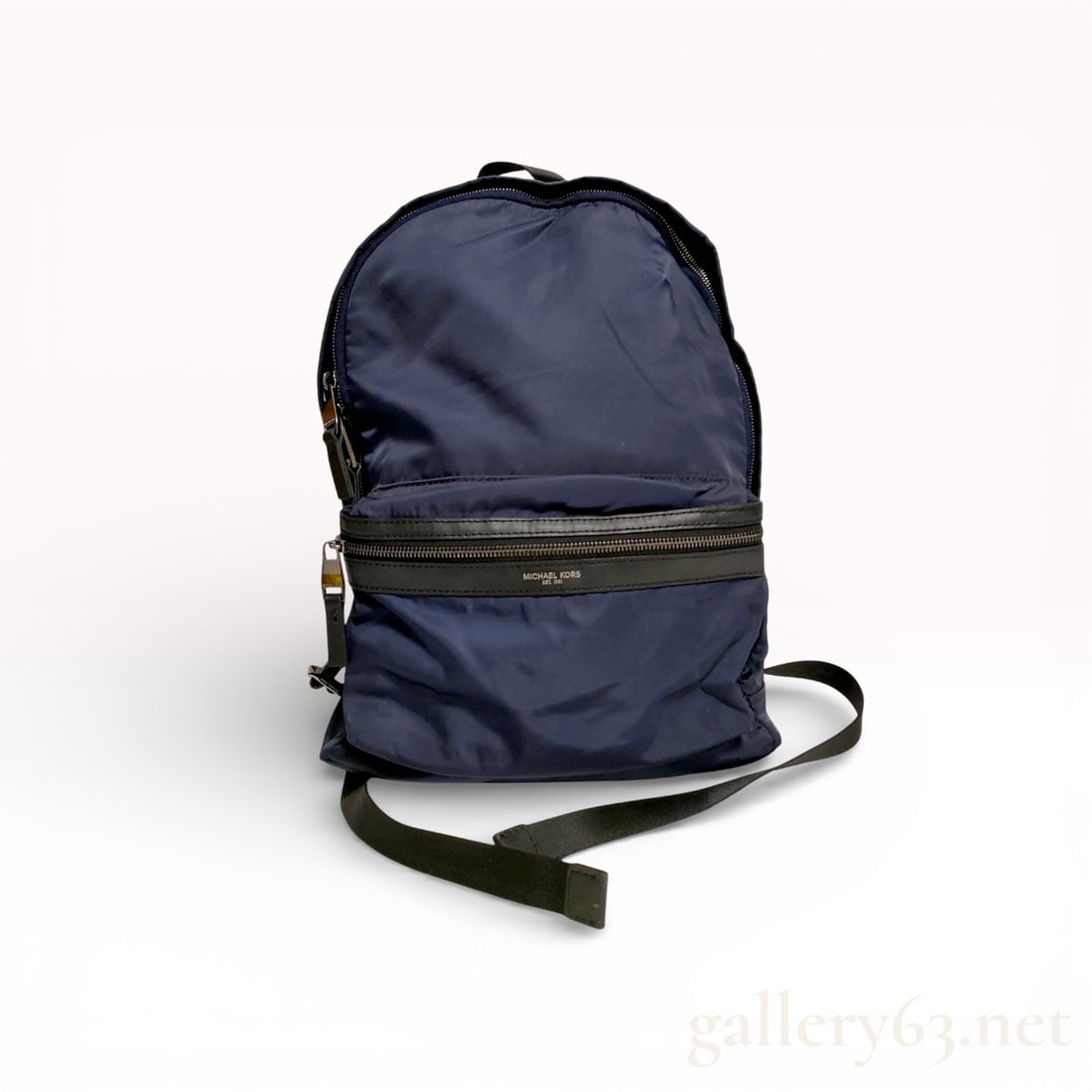 Michael Kors Kent Navy Blue Nylon and Leather Backpack: Michael Kors Kent collection backpack constructed from navy blue nylon with black leather accents and silver-tone hardware. The exterior features a large horizontal zippered front pocket with a leathe