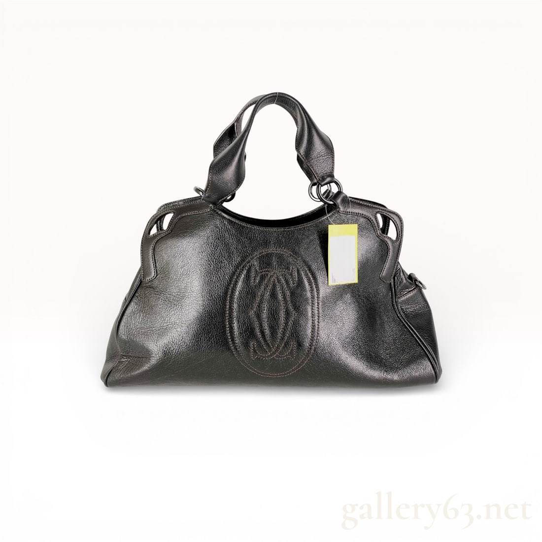 Cartier Marcello de Cartier Large Black Leather Shoulder Bag: Cartier Marcello de Cartier satchel crafted from black grained leather with gunmetal-tone hardware. The exterior features a large stitched interlocking C logo on the front, perforated corner accents,