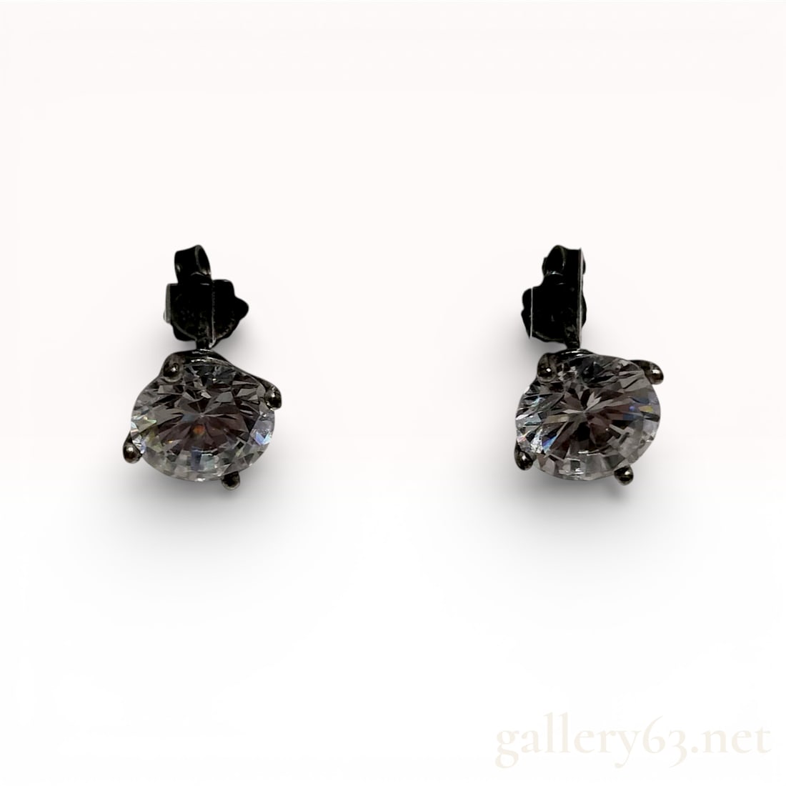 Sterling Silver Stud Earrings with Blackened Finish and Large Round Colorless Stones: This matched pair of stud earrings is crafted from sterling silver with a blackened finish, likely black rhodium or ruthenium plating. Each earring features a large, round brilliant-cut colorless ston