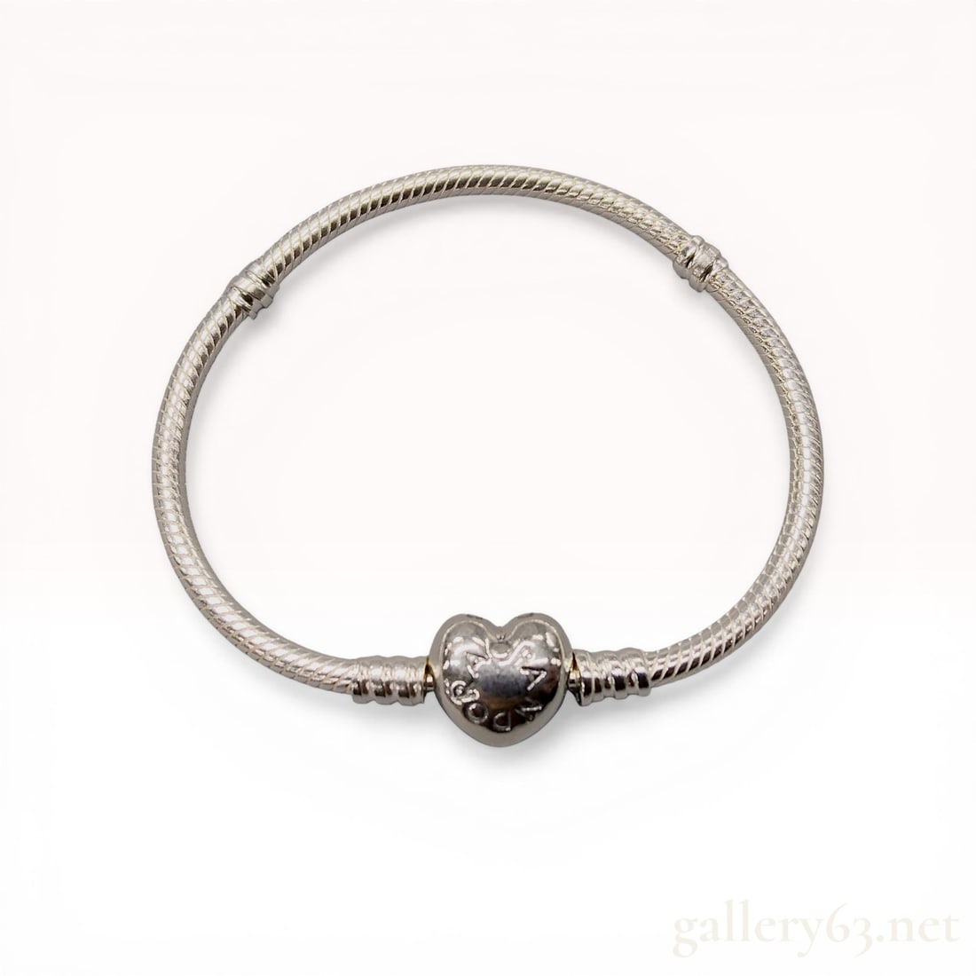 Pandora Moments Sterling Silver Heart Clasp Snake Chain Bracelet: Pandora Moments sterling silver snake chain charm bracelet featuring a hinged heart-shaped clasp. The flexible snake chain design includes two stationary threaded dividers for charm organization. The 