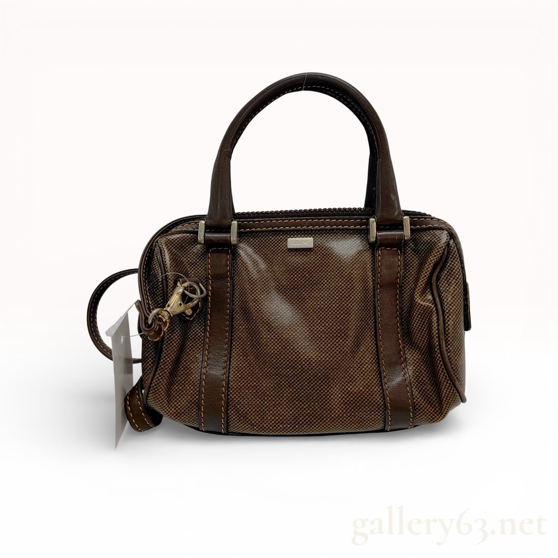 Celine Vintage Mini Boston Bag Brown Micro-Check Canvas: This vintage Celine top handle bag is crafted from a brown micro-check woven fabric canvas with dark brown leather trim and handles. The exterior features a structured silhouette with dual rolled leat