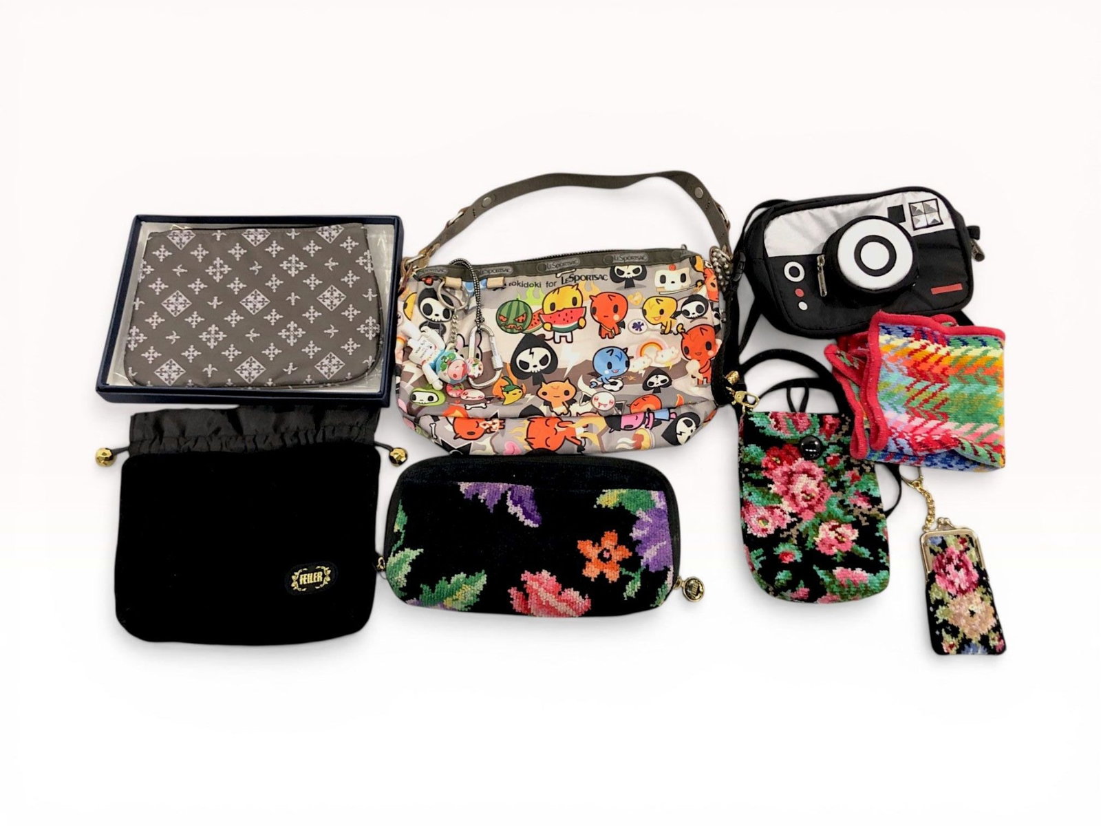 An Assortment of Designer Bags and Pouches Including tokidoki for LeSportsac Inferno Pattern and: This collection features a tokidoki for LeSportsac shoulder bag in the 2006 Inferno pattern, alongside various chenille accessories by Feiler and a monogrammed pouch by Russet. The tokidoki bag is con