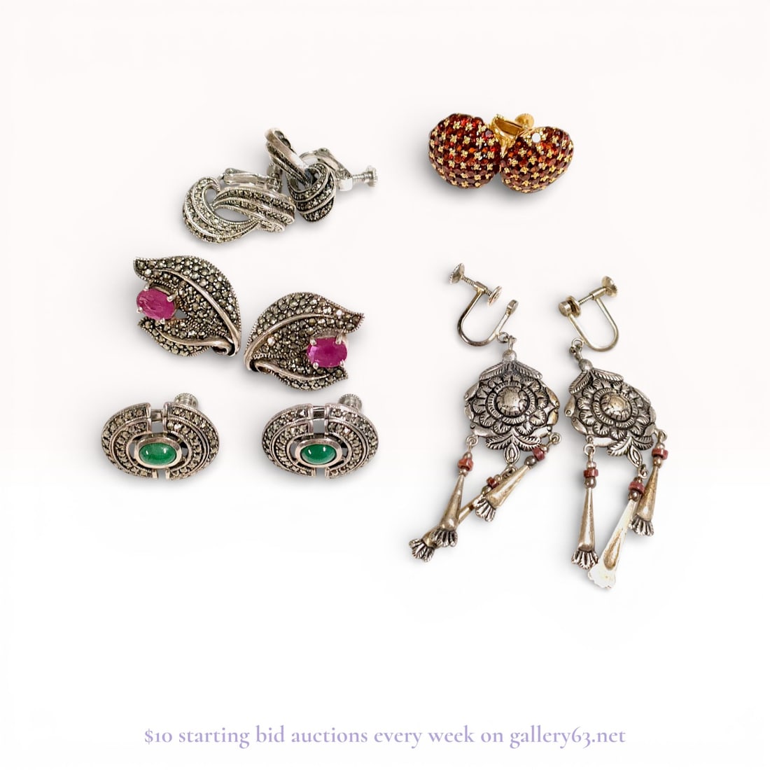A Collection of Vintage Mid-Century Sterling Silver and Marcasite Earrings: A collection of five pairs of vintage earrings featuring sterling silver and marcasite, mid-20th century. The group includes gilt sterling silver garnet pave dome earrings, marcasite-set scroll and le