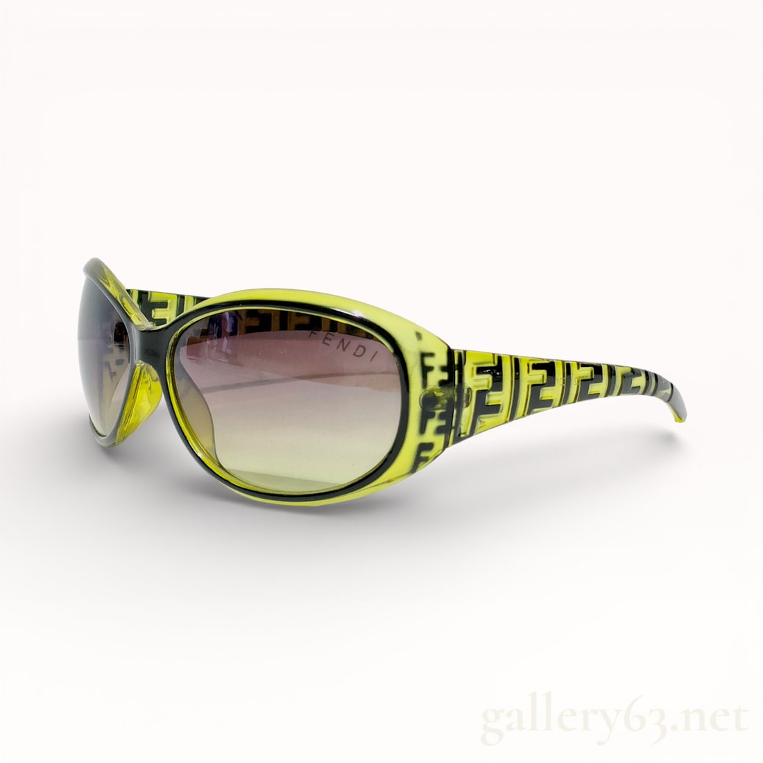 Fendi 5522 Zucca Logo Chartreuse Acetate Sunglasses: Fendi sunglasses, model 5522, made in Italy. Translucent chartreuse acetate frames featuring a repeating black Zucca logo print and gradient-tinted lenses. Gold-tone metal hinges connect the temples, 