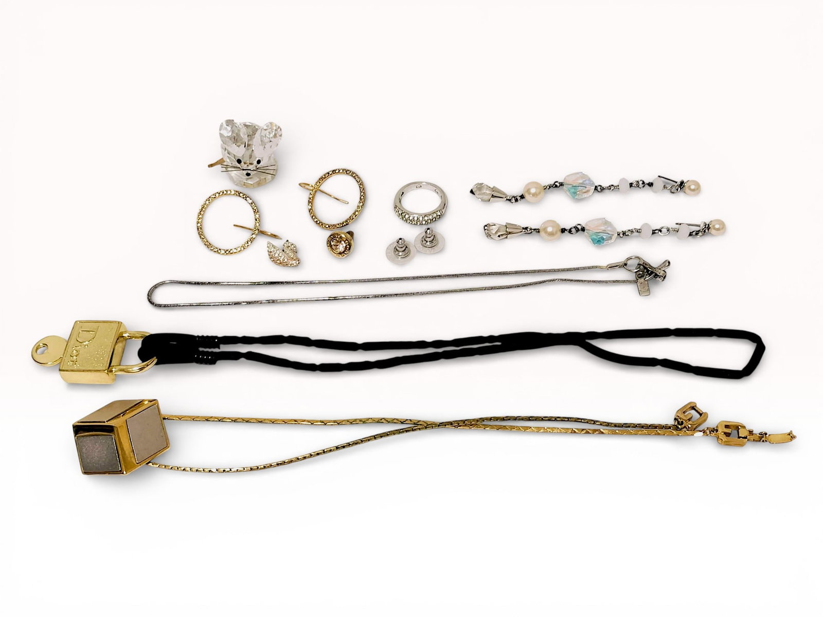 Coach, Swarovski, Dior Mixed Jewelry / Accessory Estate Lot: Estate lot offered as shown, including all items visible in the images. Offered as a single lot with no individual examination; contents and condition vary and may include wear, damage, or missing ele