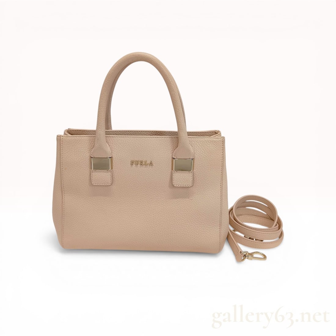 Furla Cassandra M Pebbled Leather Satchel in Nude: Furla Cassandra M satchel in nude pebbled leather, contemporary. This structured tote features dual rolled top handles with gold-tone hardware accents, a detachable shoulder strap, and side gussets wi