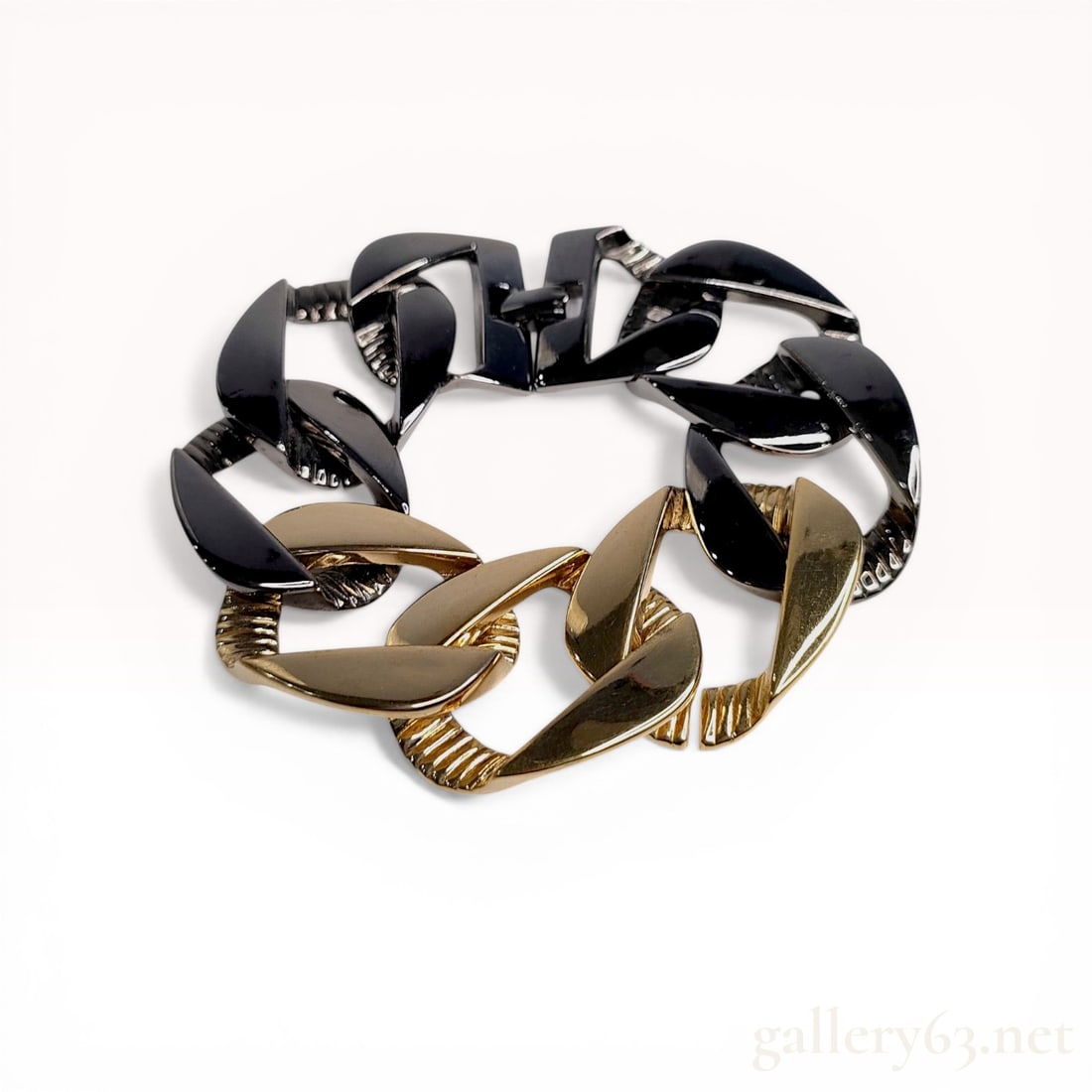 Givenchy Two-Tone Chunky Curb Link Bracelet: Givenchy chunky curb-link bracelet featuring a two-tone plated base metal design. The bracelet is composed of oversized, angular links in polished yellow gold-tone and gunmetal finishes with ribbed in