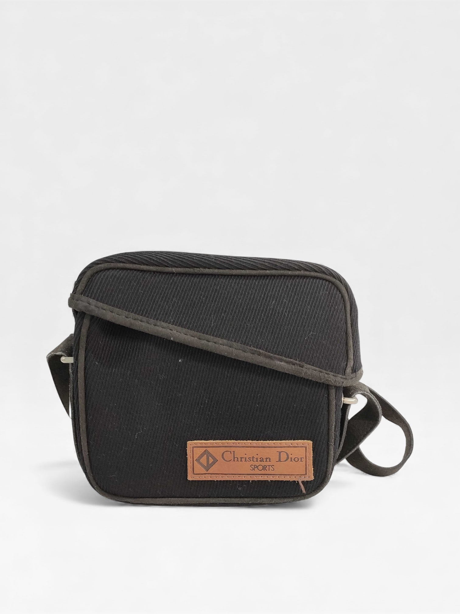Christian Dior Sports Small Crossbody Messenger Bag: Christian Dior Sports small crossbody messenger bag, late 20th century. Features a black ribbed textile exterior with grey suede piping and an adjustable suede shoulder strap with silver-tone hardware