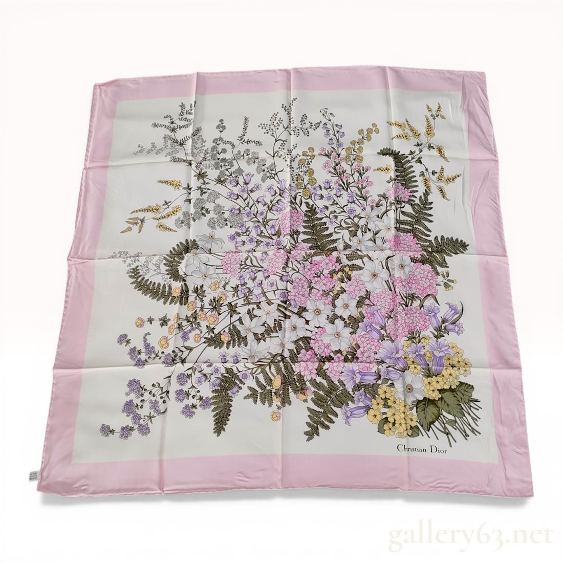 Christian Dior Silk Floral Square Scarf with Pink Border: Christian Dior square silk scarf featuring a central multi-colored botanical floral bouquet design. The motif is set on a cream ground with a wide pale pink border and includes rendered carnations, be
