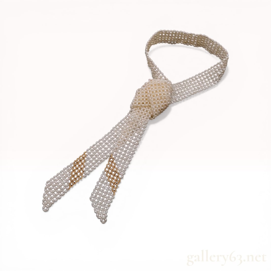 Beaded Freshwater Rice Pearl and Gold-Toned Mesh Tie Necklace: Beaded cravat-style necklace featuring a flexible, open-work lattice mesh construction. The piece is composed of white freshwater rice pearls accented by two diagonal bands of round, gold-toned metall
