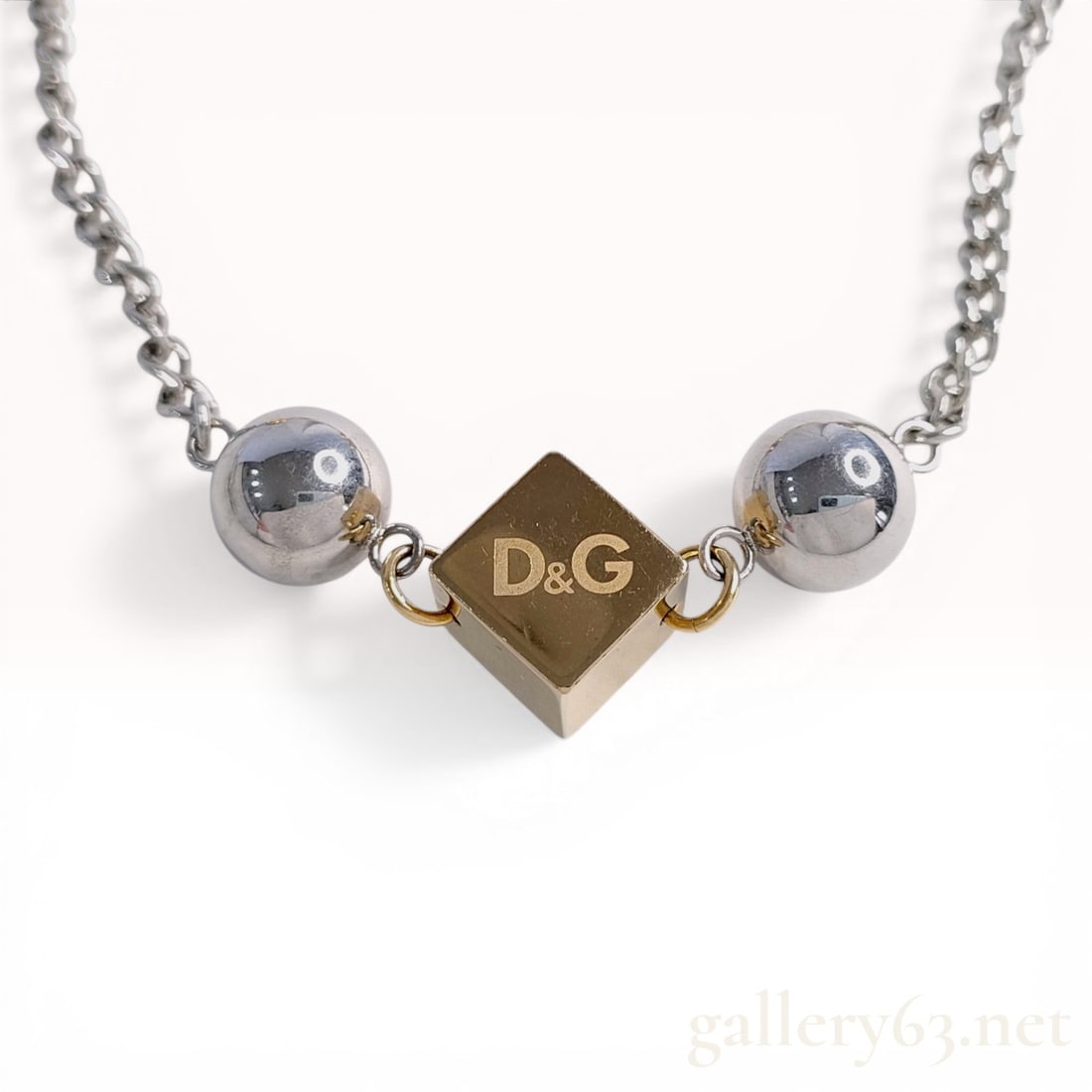 D&G Dolce and Gabbana Two-Tone Cube and Bead Fashion Necklace: D&G Dolce and Gabbana fashion necklace, early 2000's. The design features a two-tone gold-tone and silver-tone curb link chain accented with spherical beads and three cubic stations. Each cube and