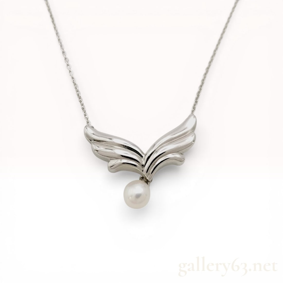 Mikimoto Sterling Silver and Akoya Pearl Angel Wings Necklace: Mikimoto sterling silver necklace featuring a stylized angel wing motif and a cultured Akoya pearl. The polished V-shaped pendant is integrated into a fine cable link chain with a spring ring clasp an
