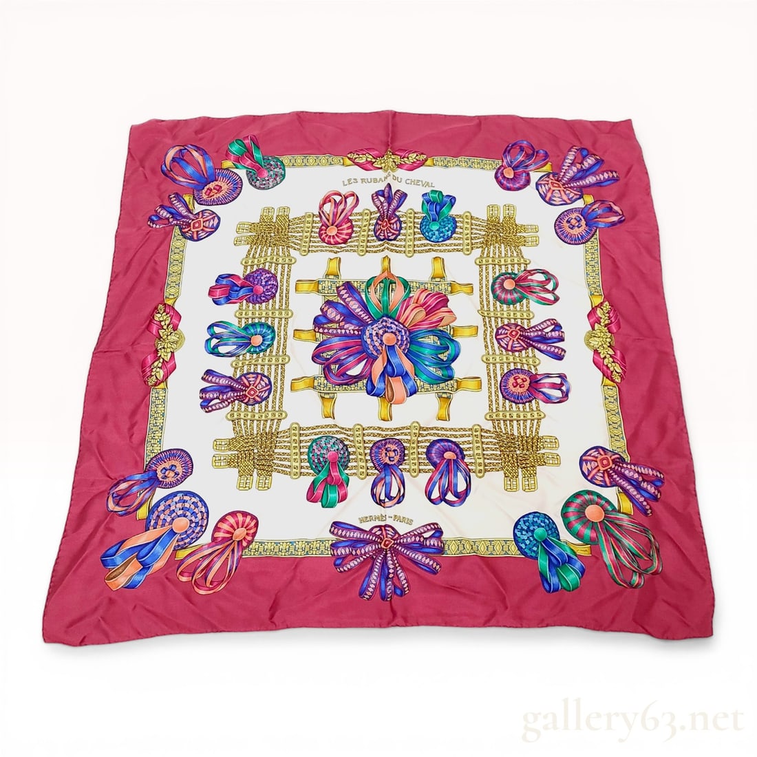 Hermes Les Rubans du Cheval Silk Twill Scarf: Hermes silk twill scarf in the Les Rubans du Cheval pattern, circa 1993. Features various multicolored prize ribbon rosettes and a central medallion on a cream ground with a wide burgundy border. Incl