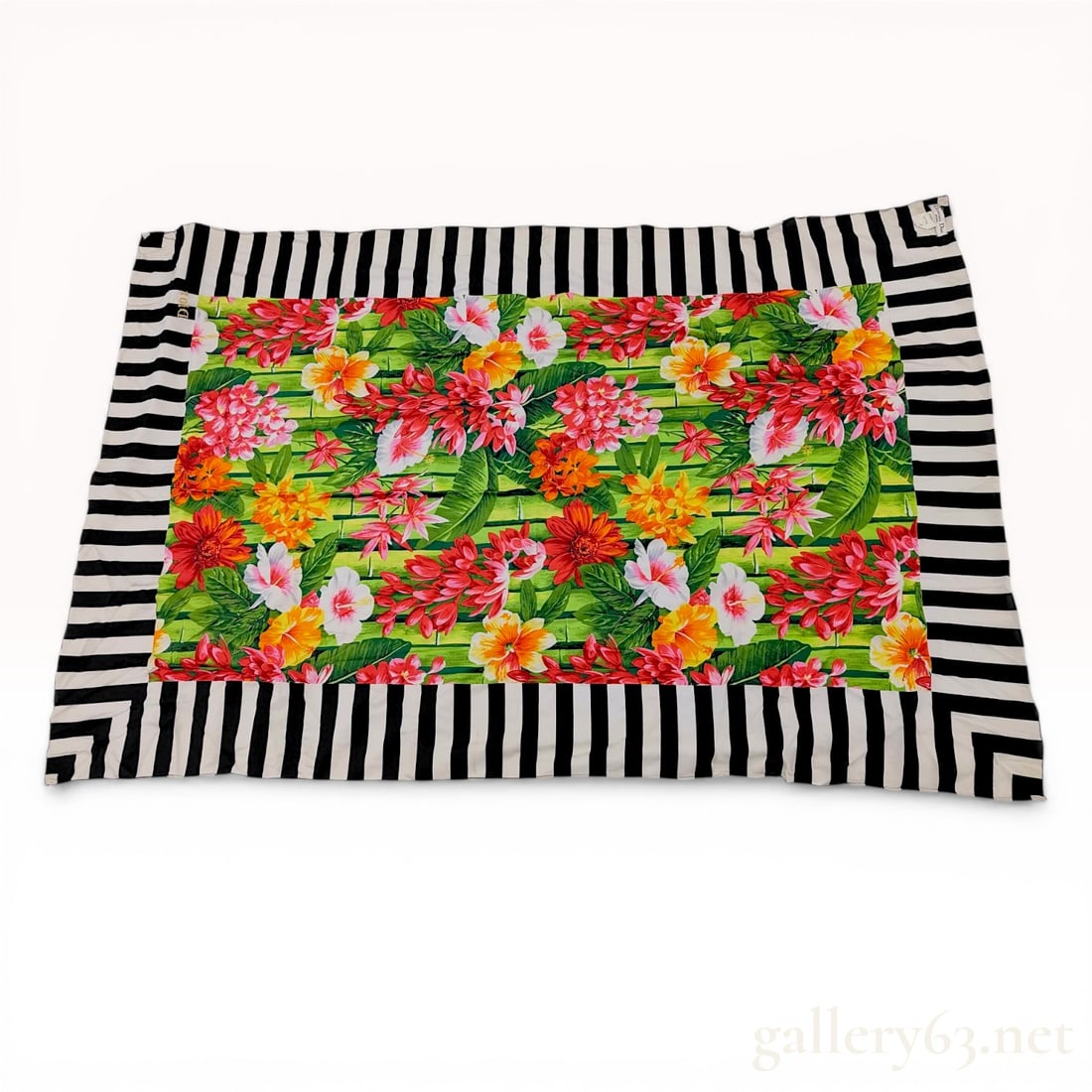 Christian Dior Sports Tropical Floral and Striped Jersey Shawl: Christian Dior Sports jersey scarf, late 20th century. Vibrant tropical hibiscus motif on a green bamboo-striped field, finished with a black and white striped border and a gold embroidered signature.