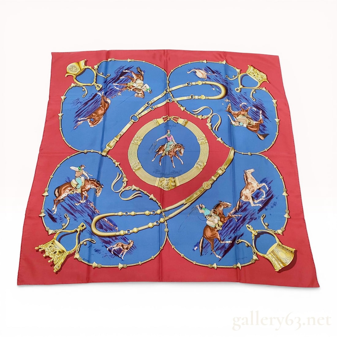 Hermes La Pampa Silk Scarf: Hermes silk scarf in the La Pampa pattern, designed by Jean de Fougerolle and originally issued in 1970. The composition features equestrian gaucho scenes in blue and gold medallions set against a vib