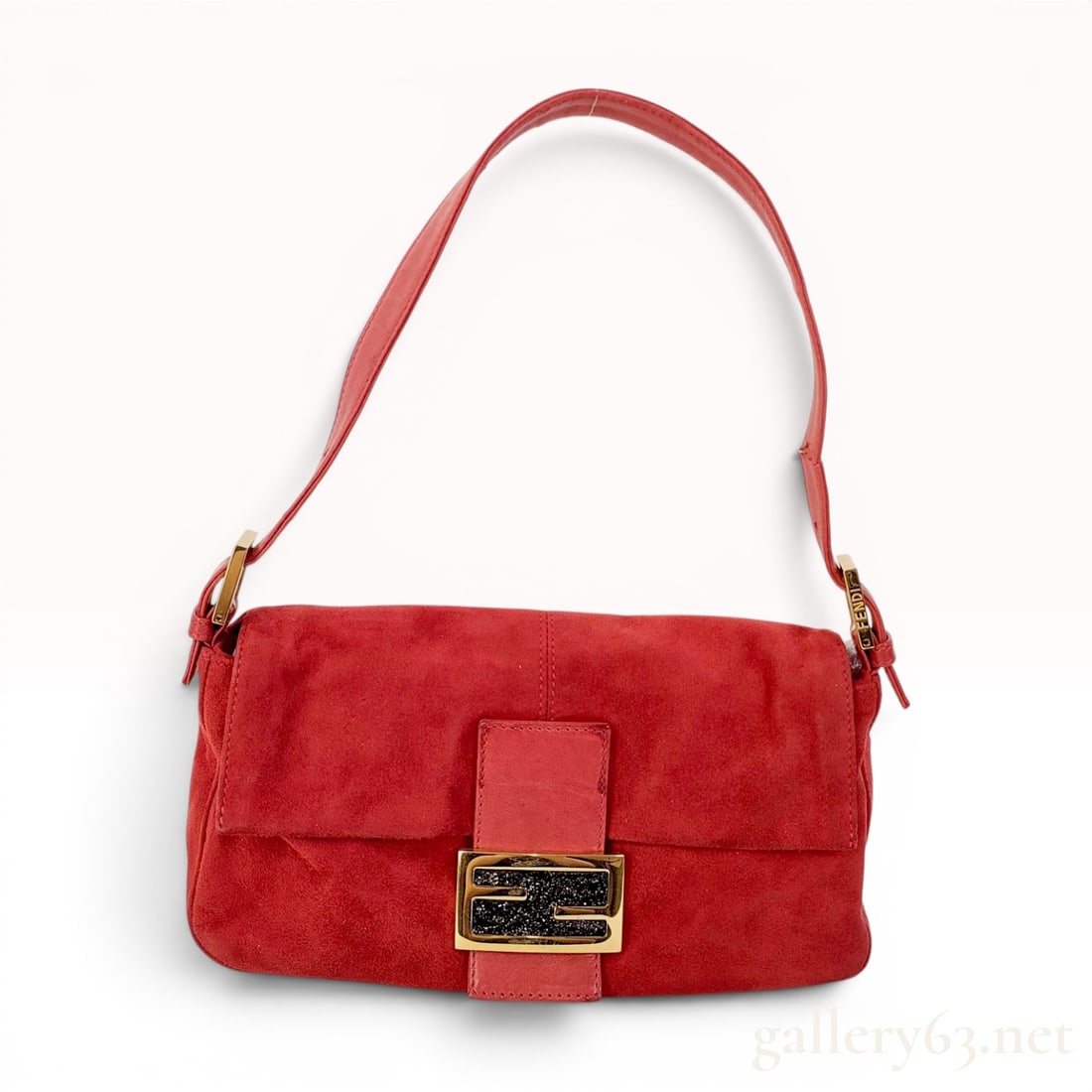 Fendi Red Suede Mama Baguette Shoulder Bag: A Fendi Mama Baguette shoulder bag constructed from red suede with tonal leather trim and an adjustable leather shoulder strap. The front flap features a gold-tone metal FF logo buckle accented with a