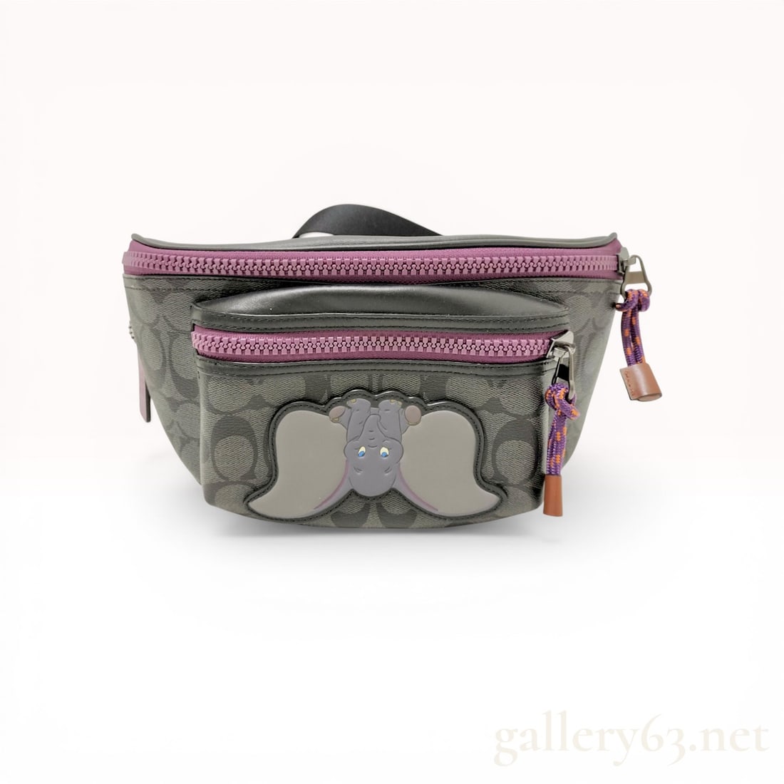 Disney x Coach My One True Love Dumbo Signature Academy Belt Bag: Disney x Coach Academy belt bag from the Dumbo collection, featuring a front character applique. The piece is crafted from charcoal gray signature coated canvas with smooth black leather trim, purple 