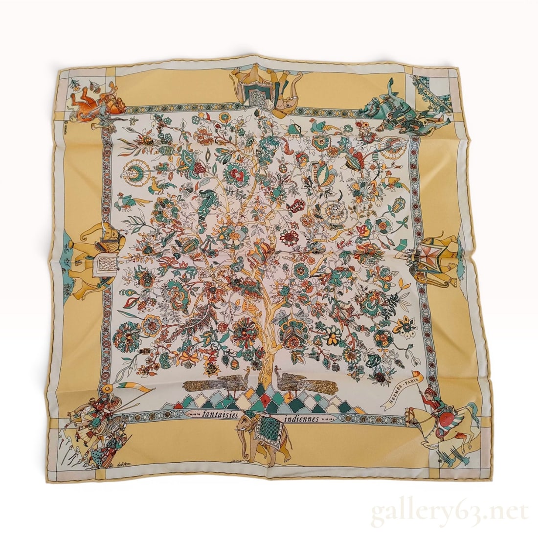 Herm?¨s Fantaisies Indiennes Silk Pocket Square: An Hermès silk pocket square in the Fantaisies Indiennes pattern, designed by artist Loïc Dubigeon. The design features a central Tree of Life motif with intricate multi-colored floral and